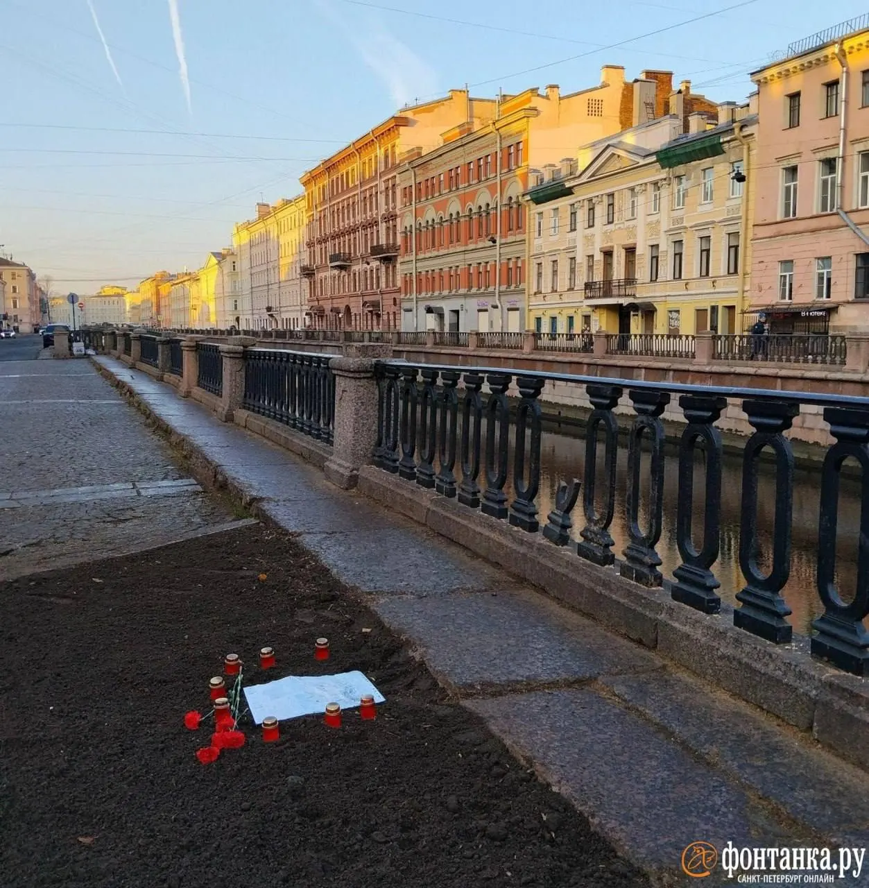 На месте ранее стоявшего дерева на канале Грибоедова обустроили мемориальное место: свечи, цветы и памятная надпись.